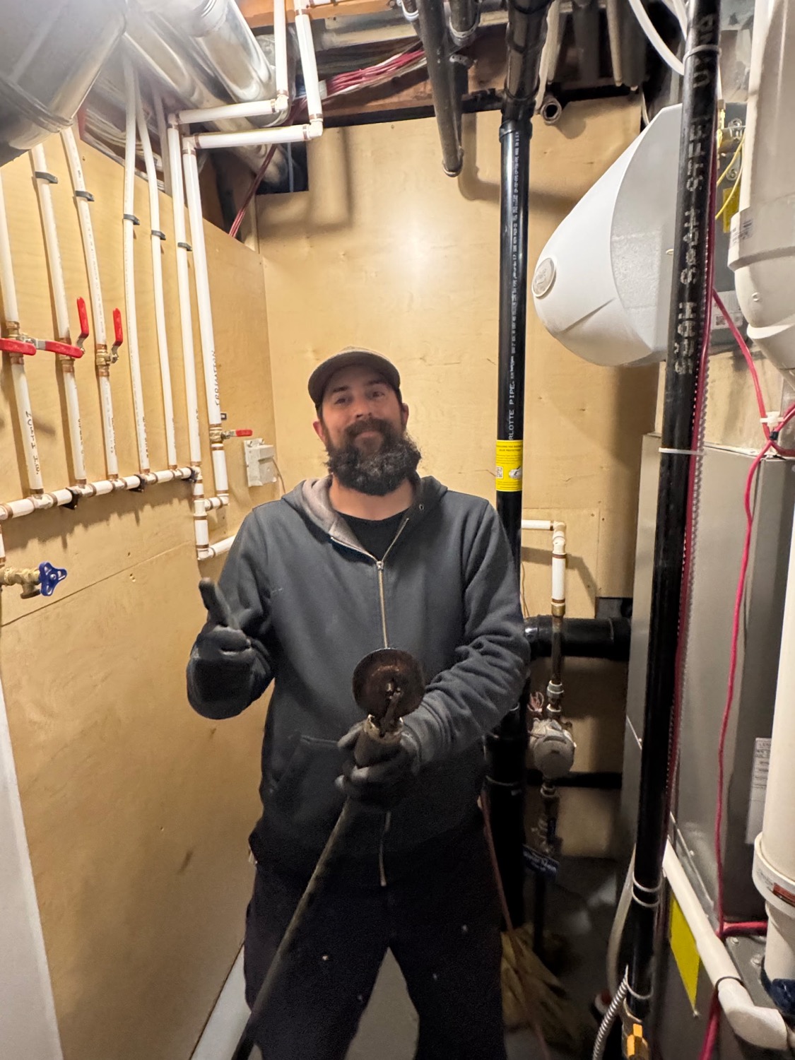 Brandon, owner of The Drain Wizards, on the job giving a thumbs up
